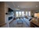 Living room with stone fireplace, tv, large sofa, and view of back yard at 367 Josef Cir, Fort Lupton, CO 80621