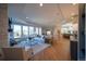 Spacious living room with a fireplace, comfortable seating, and expansive windows at 367 Josef Cir, Fort Lupton, CO 80621