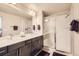 Elegant bathroom with double sink vanity, large mirror, and a glass-enclosed shower at 8833 Meade St, Westminster, CO 80031