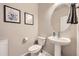 Cozy half-bathroom features pedestal sink, oval mirror, and neutral wall decor at 8833 Meade St, Westminster, CO 80031