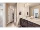 Bathroom with double sink vanity, recessed lighting, and open access to a walk-in closet at 8833 Meade St, Westminster, CO 80031