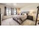 Comfortable bedroom with upholstered headboard, neutral colors, and lots of natural light at 8833 Meade St, Westminster, CO 80031