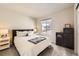 Cozy bedroom with a queen bed, side tables, and a black storage unit at 8833 Meade St, Westminster, CO 80031