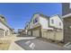 Well-maintained townhomes with stone accents, driveways and light-colored facades at 8833 Meade St, Westminster, CO 80031