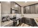 Sleek kitchen with stainless steel appliances, modern cabinets, and granite countertops at 8833 Meade St, Westminster, CO 80031