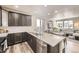Modern kitchen features stainless appliances, granite countertops, and opens to the living space at 8833 Meade St, Westminster, CO 80031