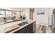Kitchen with a large island and stainless steel dishwasher connects to a spacious living area at 8833 Meade St, Westminster, CO 80031