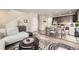 Open-concept living room and dining area featuring modern decor and hardwood floors at 8833 Meade St, Westminster, CO 80031