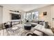 Comfortable living room featuring a large sectional sofa, stylish shelves, and windows at 8833 Meade St, Westminster, CO 80031