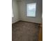 Bedroom featuring two windows for natural light and neutral colored carpet at 165 Garland St, Lakewood, CO 80226