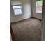 Cozy bedroom featuring two windows for natural light and neutral colored carpet at 165 Garland St, Lakewood, CO 80226