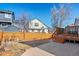 Spacious backyard with a patio, an adjacent wooden fence, and a view of neighboring homes at 8731 Wildrye Cir, Parker, CO 80134