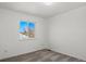 Empty bedroom with light gray carpet, white walls, and a large window at 8731 Wildrye Cir, Parker, CO 80134