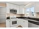 Kitchen featuring black countertops, stainless steel dishwasher, gas range, and built in microwave at 8731 Wildrye Cir, Parker, CO 80134