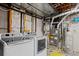 Bright laundry room featuring a newer washer and dryer with mechanicals nearby at 8731 Wildrye Cir, Parker, CO 80134