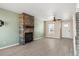 Inviting living room with a stone fireplace, light wood floors, and large windows at 8731 Wildrye Cir, Parker, CO 80134