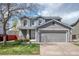 Charming two-story home featuring a gray exterior, well-maintained lawn, and an attached two-car garage at 5237 S Malaya Way, Centennial, CO 80015
