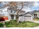 Charming two-story home with a well-manicured lawn, gray siding, and a two car garage at 5237 S Malaya Way, Centennial, CO 80015