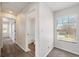 Neutral hallway leading to a bathroom and bedroom with carpet flooring and a view from the window at 5237 S Malaya Way, Centennial, CO 80015