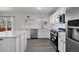 Bright kitchen with an island, stainless steel appliances, and white cabinets with subway tile backsplash at 5237 S Malaya Way, Centennial, CO 80015