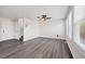 Bright living room with stairs to second story, large windows, a ceiling fan, and vinyl wood-look flooring at 5237 S Malaya Way, Centennial, CO 80015