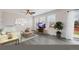 Bright living room with large windows, neutral tones, a ceiling fan, and vinyl wood-look flooring at 5237 S Malaya Way, Centennial, CO 80015