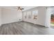 Bright living room with large windows, neutral tones, a ceiling fan, and vinyl wood-look flooring at 5237 S Malaya Way, Centennial, CO 80015