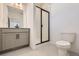 Modern bathroom with gray vanity, shower, and white tile at 9639 Browns Peak Cir, Littleton, CO 80125