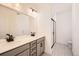 Double vanity bathroom with modern fixtures and a walk-in shower at 9639 Browns Peak Cir, Littleton, CO 80125