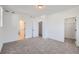 Spacious bedroom with carpet flooring and access to a bathroom and closet at 9639 Browns Peak Cir, Littleton, CO 80125
