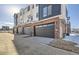 Attached garage with modern doors and brick exterior at 9639 Browns Peak Cir, Littleton, CO 80125