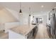 Open concept kitchen island with granite countertop and pendant lighting at 9639 Browns Peak Cir, Littleton, CO 80125