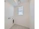 Clean laundry room with tile floor and a window for natural light at 9639 Browns Peak Cir, Littleton, CO 80125