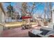 Backyard featuring an outdoor dining area with a red umbrella, an outdoor living space and a hot tub at 1351 Reed St, Lakewood, CO 80214