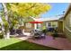 Cozy backyard featuring a patio with dining set and hot tub, perfect for outdoor entertaining at 1351 Reed St, Lakewood, CO 80214