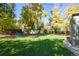 Picture of a spacious backyard featuring a large, green lawn and mature trees for shade at 1351 Reed St, Lakewood, CO 80214