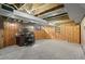 Spacious basement with wood paneling, carpet, and exposed ceiling beams, perfect for an office or living area at 1351 Reed St, Lakewood, CO 80214