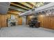 Basement with a stone fireplace, office area, and wood-paneled walls at 1351 Reed St, Lakewood, CO 80214