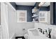 Modern bathroom with subway tile, black and white floors, and updated fixtures at 1351 Reed St, Lakewood, CO 80214