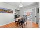 Bright dining room with hardwood floors and mountain painting at 1351 Reed St, Lakewood, CO 80214