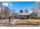 Charming single-story home with a well-manicured lawn and a cozy front porch at 1351 Reed St, Lakewood, CO 80214