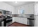 Well-maintained kitchen featuring modern appliances, granite countertops, and hardwood floors at 1351 Reed St, Lakewood, CO 80214