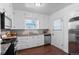 Well-lit kitchen featuring stainless steel appliances, white cabinetry, and granite countertops at 1351 Reed St, Lakewood, CO 80214