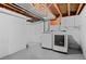 Bright laundry area featuring a side-by-side washer and dryer, with white walls and simple shelving for storage at 1351 Reed St, Lakewood, CO 80214