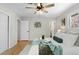 Bright bedroom featuring hardwood floors, a ceiling fan, and a calming color palette at 3190 Ward Ct, Wheat Ridge, CO 80215