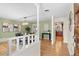 Open dining room with hardwood floors and stylish light fixture next to the kitchen at 3190 Ward Ct, Wheat Ridge, CO 80215