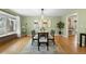 Dining room with hardwood floors, decorative rug and hanging light fixture at 3190 Ward Ct, Wheat Ridge, CO 80215
