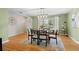 Spacious dining area with hardwood floors and natural light from a large window at 3190 Ward Ct, Wheat Ridge, CO 80215