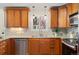 Charming kitchen with granite countertops, wooden cabinets, stainless steel appliances and a window view at 3190 Ward Ct, Wheat Ridge, CO 80215