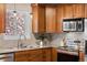 Updated kitchen featuring granite countertops, stainless steel appliances, and wood cabinetry at 3190 Ward Ct, Wheat Ridge, CO 80215